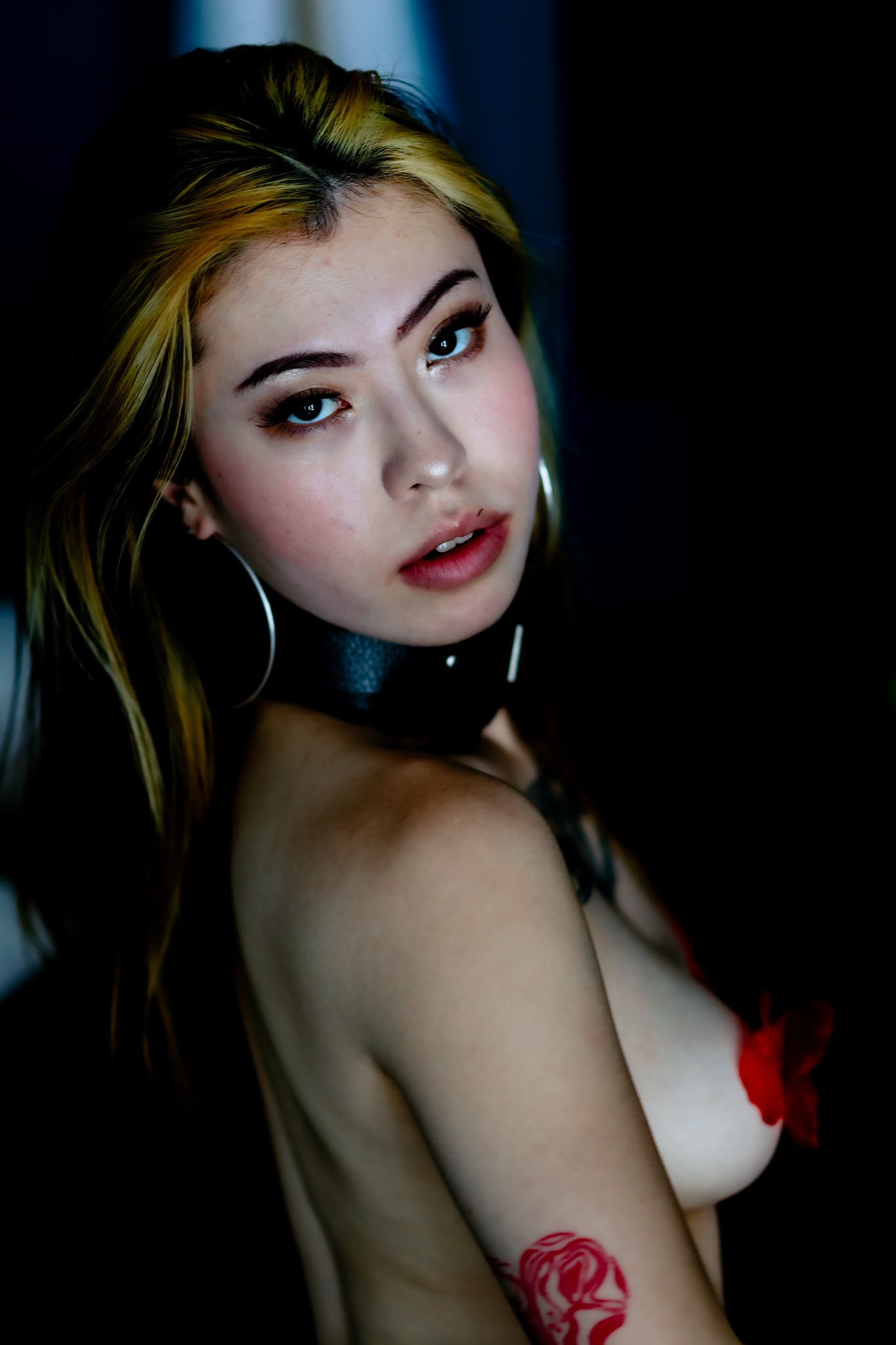 Dark editorial close-up with direct eye contact