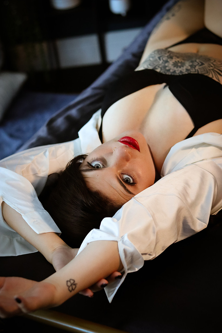 Reclining studio portrait in a white shirt