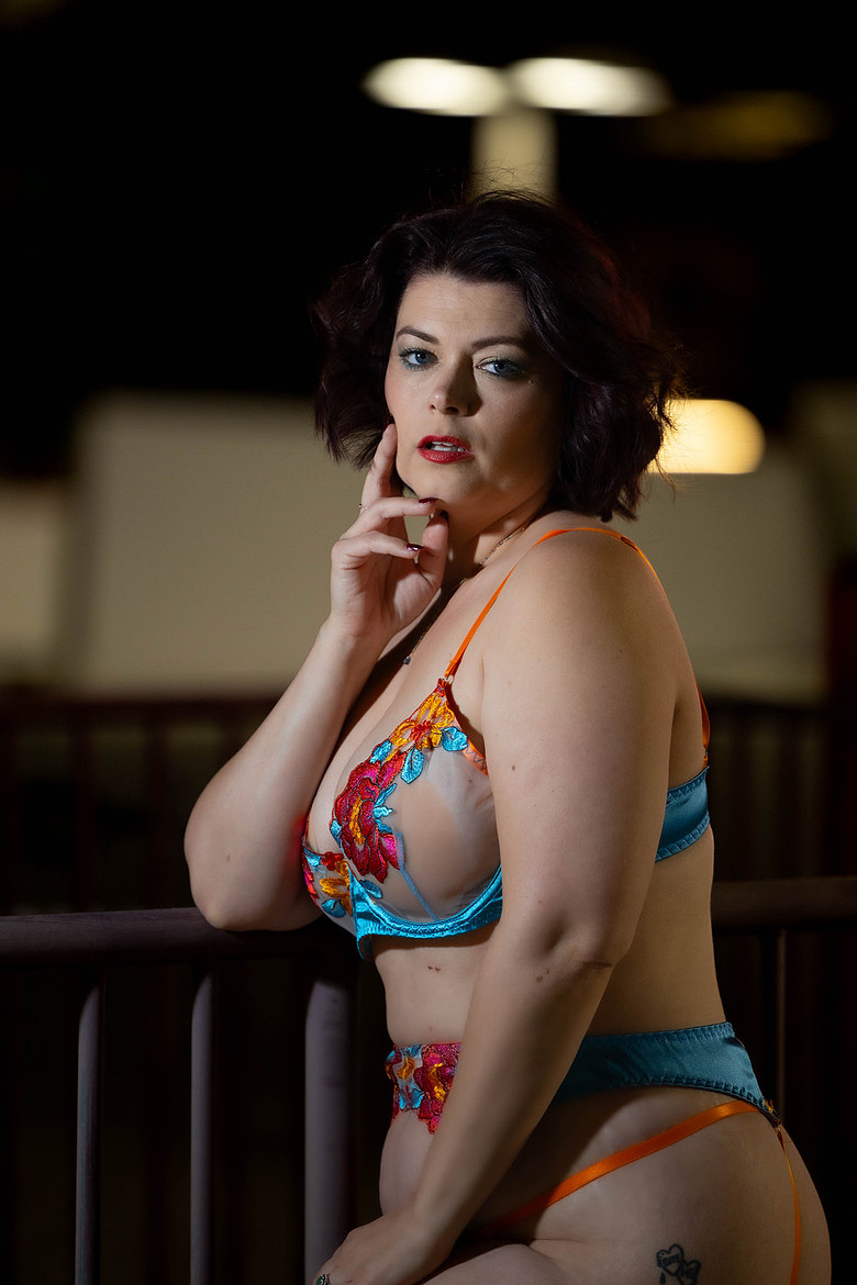 Turquoise lingerie portrait beside a Las Vegas railing